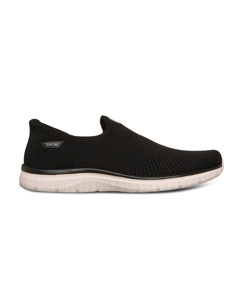 Black slip-on sneakers with white soles on a white background