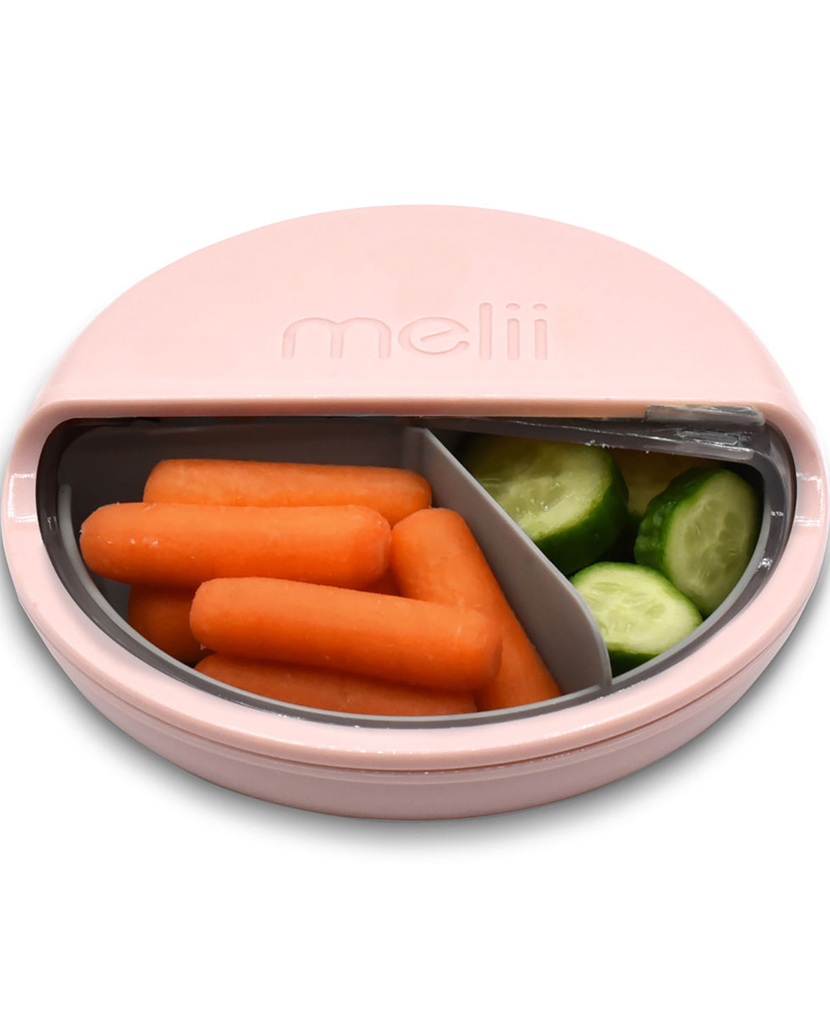 Pink snack container with compartments filled with carrots and cucumbers, featuring the brand 'meli'.