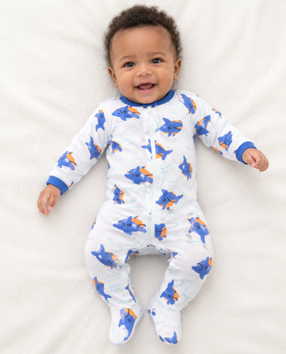 Baby boy wearing long sleeve coveralls with shark print