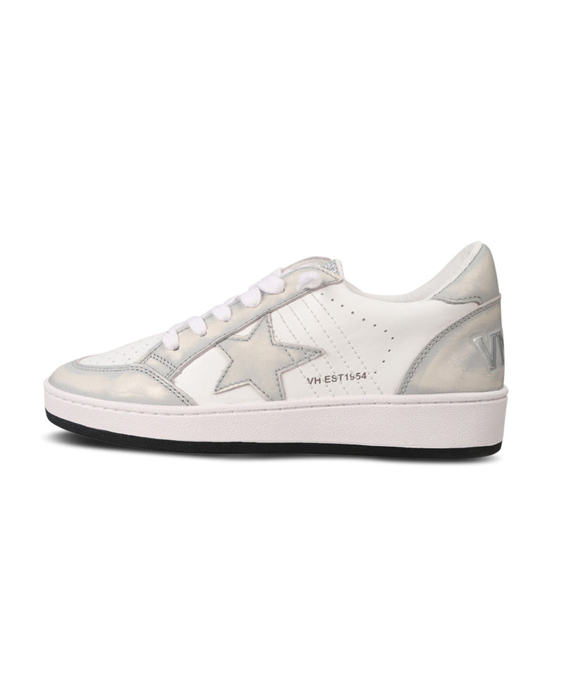 A low-top sneaker in white and metallic silver, featuring a large star patch on the side, white laces, and a thick white midsole with a black outsole.