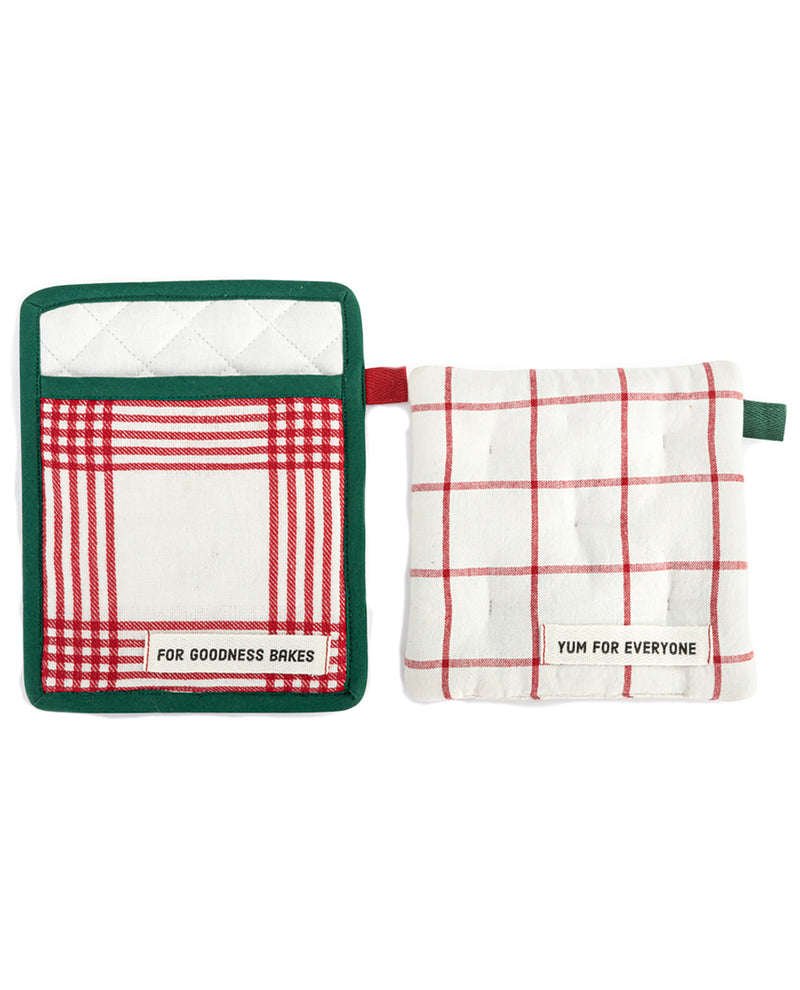 Two quilted oven mitts on a white background. The left mitt has a green border, a red and white plaid pocket, and a white label that reads 'FOR GOODNESS BRICKES'.