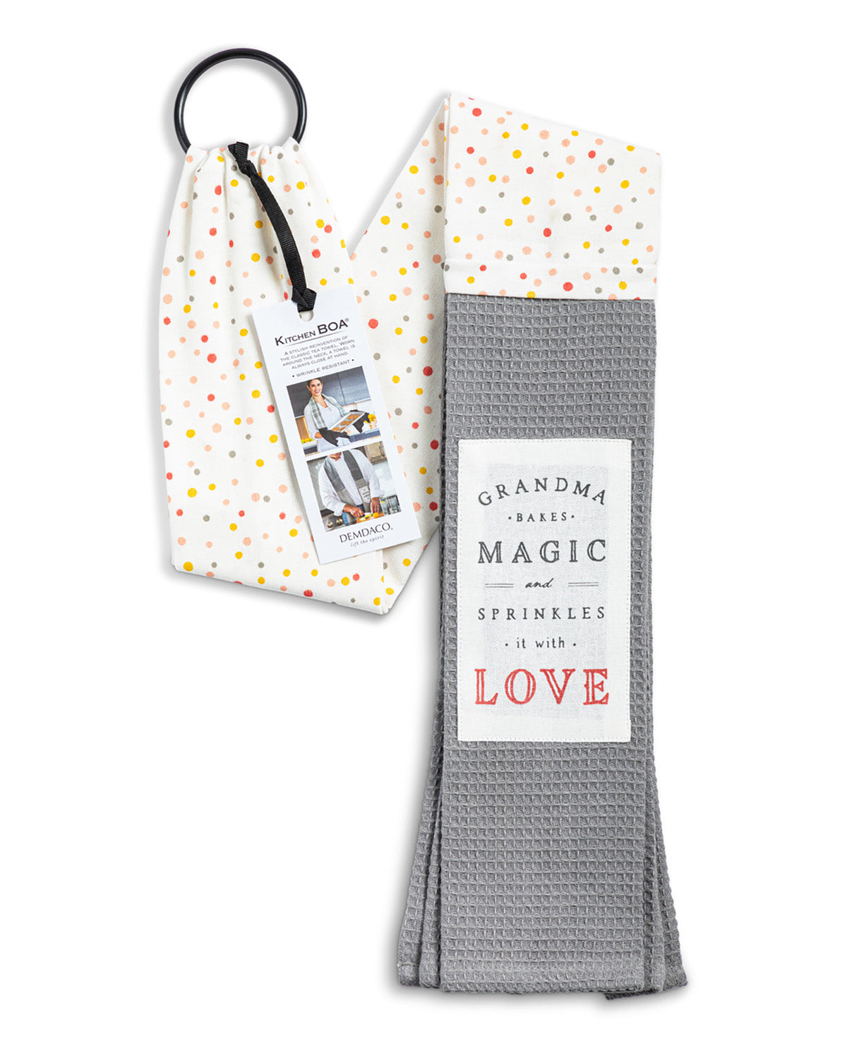 A folded gray waffle-weave kitchen towel with a white label reading 'GRANDMA BAKES MAGIC SPRINKLES it with LOVE', shown next to its white drawstring pouch with multicolored polka dots and a black hanging ring.