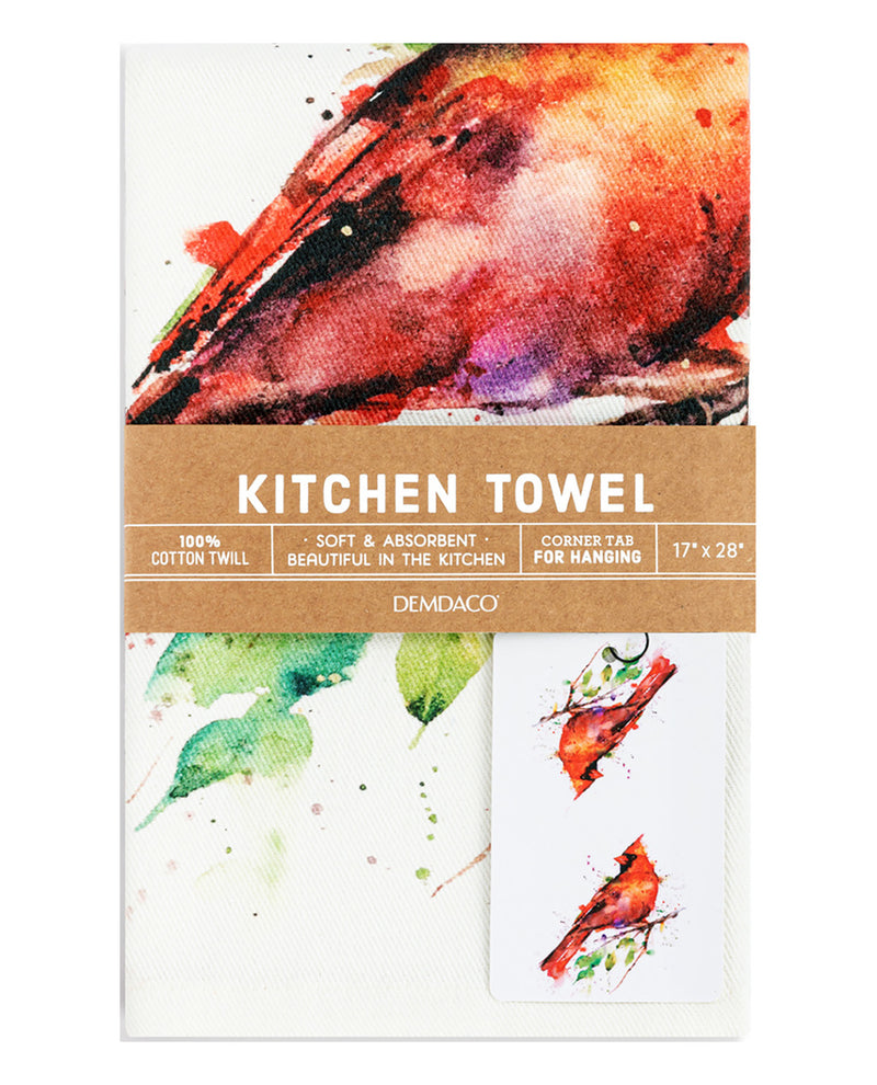 A Demdaco kitchen towel with a watercolor bird print, wrapped in a brown paper band that reads 'KITCHEN TOWEL' and shows dimensions and material details.