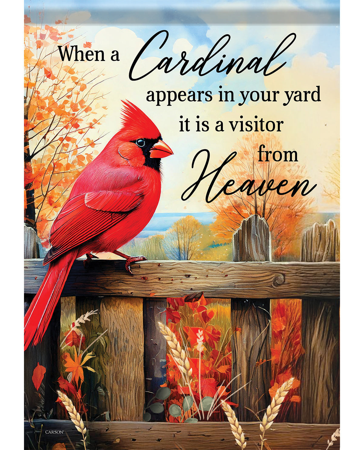 A decorative sign or print featuring a bright red cardinal perched on a wooden fence, with autumn trees in the background and the text, 'When a Cardinal appears in your yard it is a visitor from Heaven.'.
