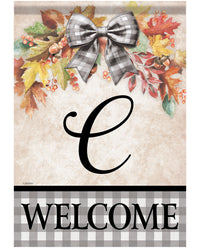 A decorative fall-themed welcome sign or door mat featuring a large black script letter C, autumn leaves, berries, and a gray-and-white gingham bow at the top, with a black-and-white gingham banner and the word WELCOME at the bottom.
