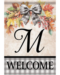 A personalized fall-themed welcome garden flag with a beige textured background, a large black script letter 'M', an autumn leaf and berry wreath with a gray-and-white gingham bow, and a bottom banner reading 'WELCOME' in black text on a gray gingham background.