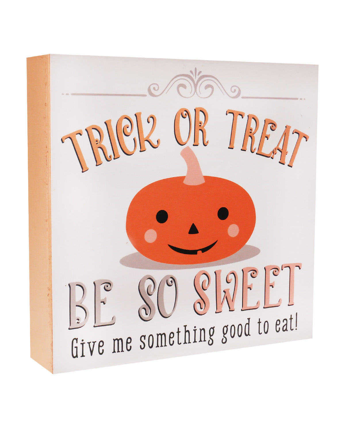 A square decorative sign with a white face and orange side edge, featuring the text 'TRICK OR TREAT BE SO SWEET Give me something good to eat!' around a cartoon orange pumpkin face.