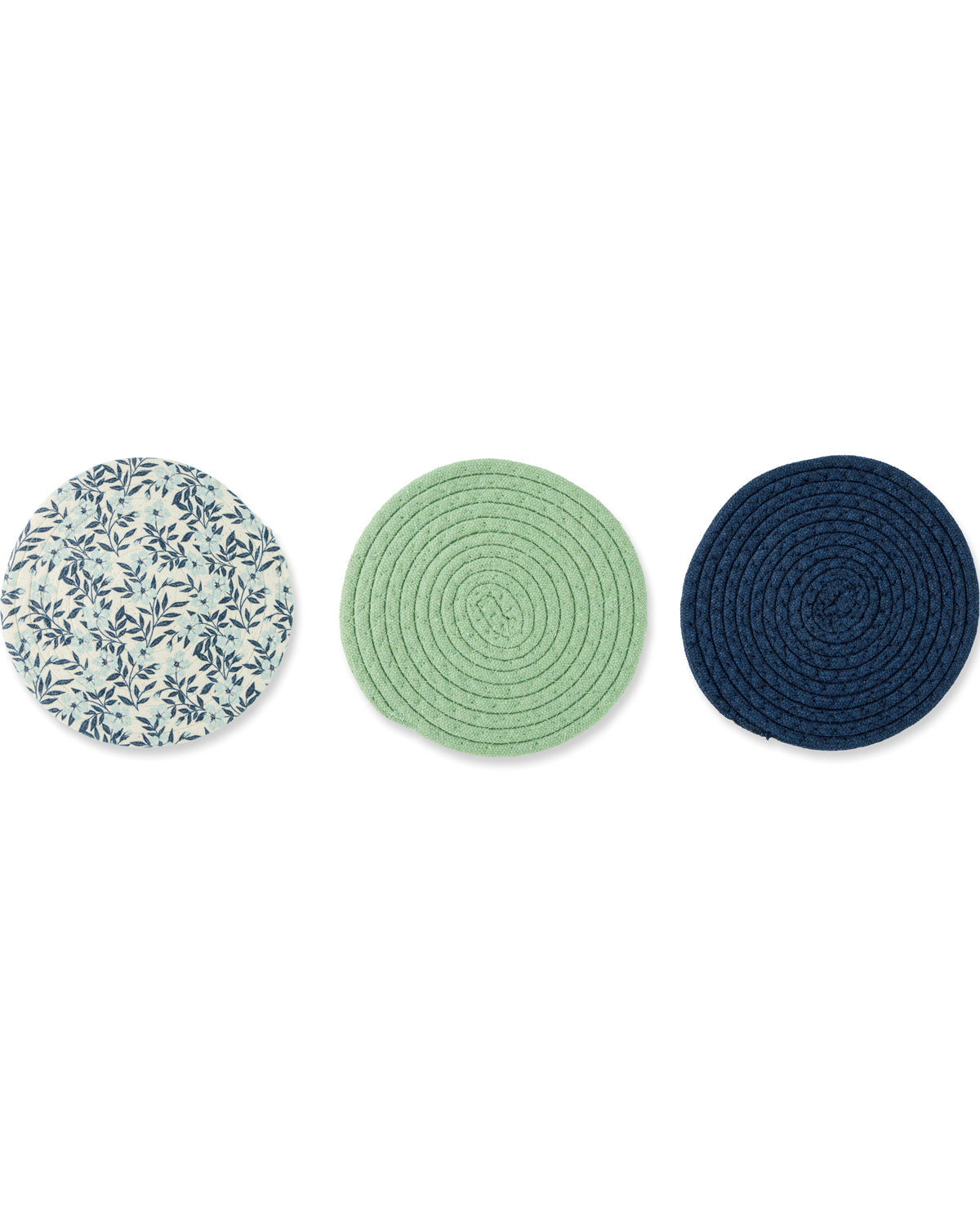 Three round braided coasters arranged horizontally on a white background. The left coaster is off-white with a blue floral pattern, the middle coaster is light green, and the right coaster is dark navy blue.