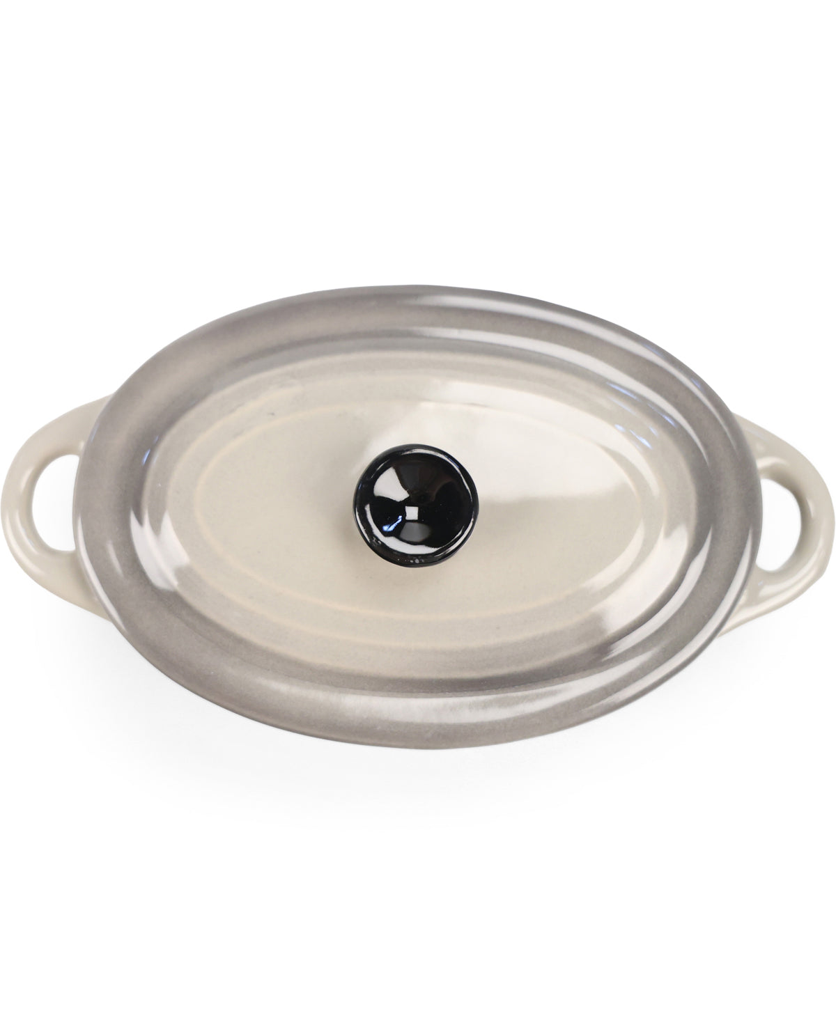 An oval glass casserole dish with a clear lid featuring a black glass knob and side handles, shown on a white background.