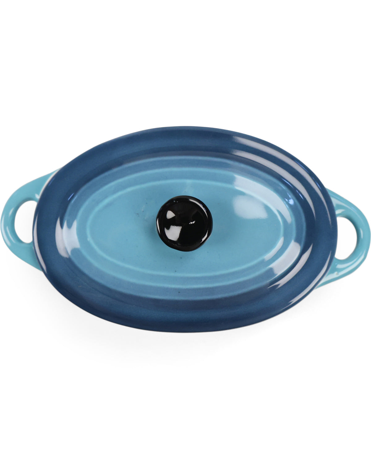 An oval-shaped enameled cast iron casserole dish with a matching lid, featuring a color gradient from light blue to dark navy blue, with a glossy black knob on the lid and light blue side handles, set against a plain white background.