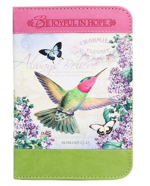 Notebook with a colorful design featuring a hummingbird, butterflies, and floral elements on a white background.