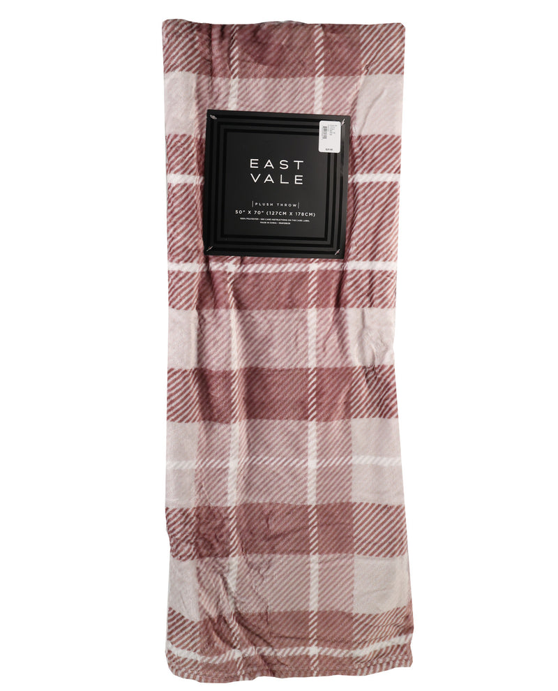 A folded plaid throw blanket in dusty rose and cream, packaged with a black paper sleeve labeled 'EAST VALE'.