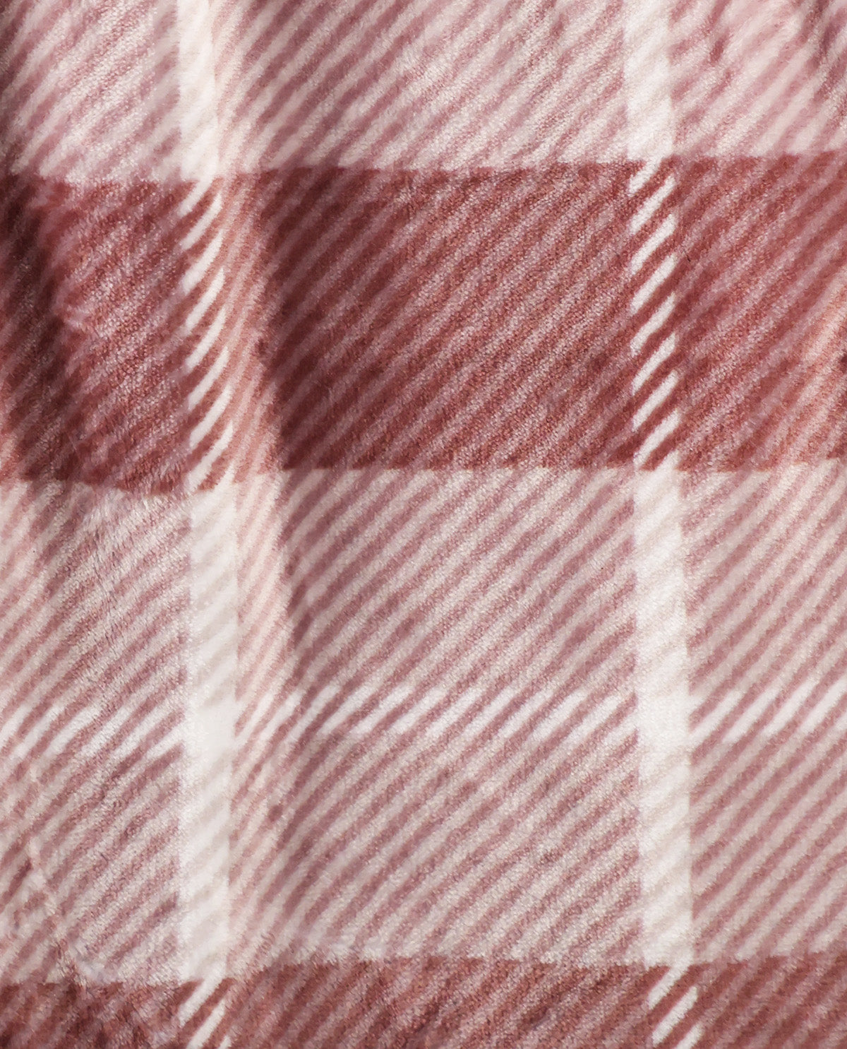 A close-up of a plaid fabric pattern in dusty rose, mauve, and off-white, showing the woven texture and stripe details.