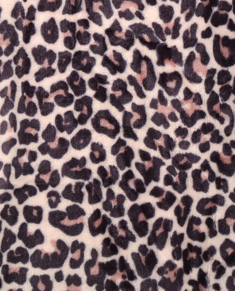 Close-up of leopard print fabric with black and pink spots on a light background