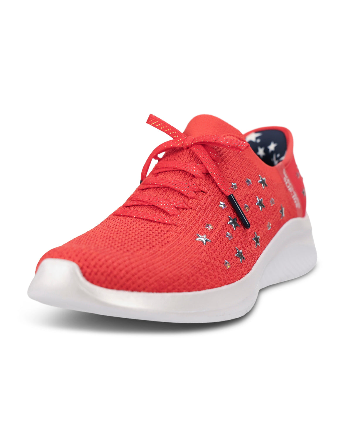 A red knit athletic sneaker with silver star-shaped studs, a red lace, and a thick white sole, shown from a three-quarters angle on a white background.