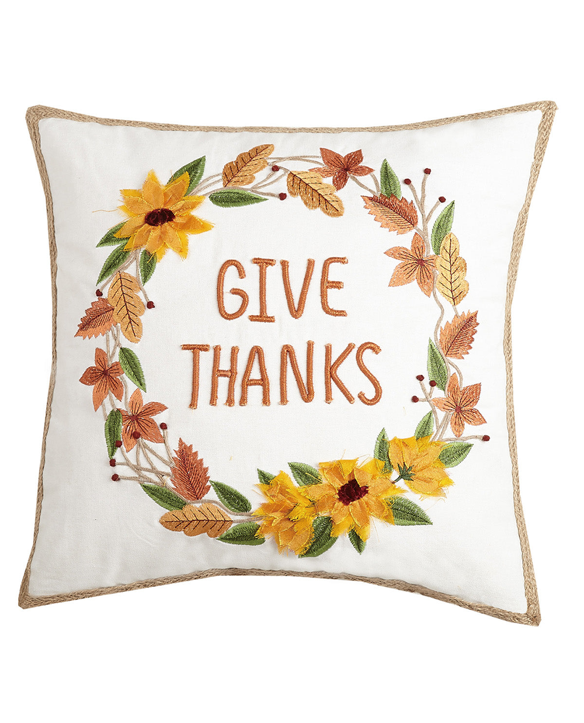 A square white throw pillow with a natural jute trim, featuring an embroidered autumn wreath with yellow sunflowers, orange and brown leaves, and the words 'GIVE THANKS' in orange-brown lettering in the center.