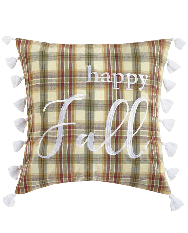 A square decorative throw pillow with a beige, green, and brown plaid pattern, featuring white embroidered text that reads 'happy Fall' and white tassels along the edges, shown against a plain white background.