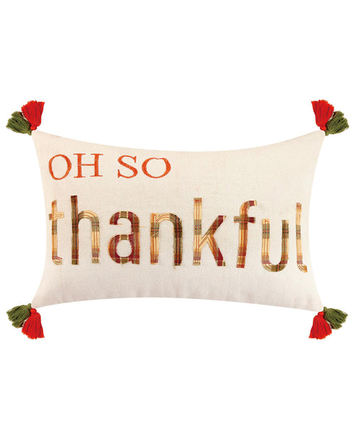 An off-white rectangular throw pillow featuring the phrase 'OH SO thankful' in autumn-themed lettering. The top portion reads 'OH SO' in orange, while 'thankful' is written below in large letters filled with a plaid pattern of orange, brown, and beige.