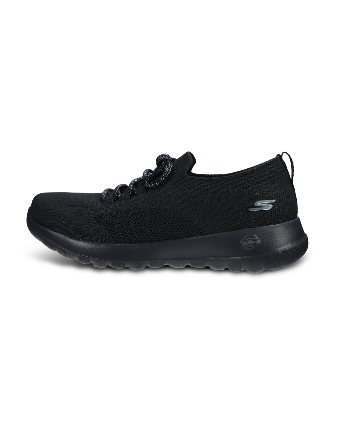 A black knit slip-on sneaker with textured laces and a thick black sole, shown from a three-quarters angle on a white background.
