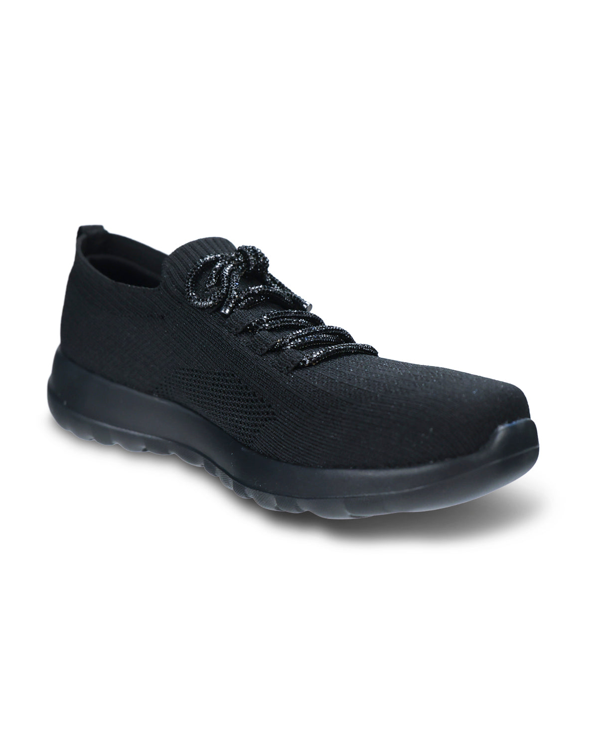 A black knit slip-on sneaker with textured laces and a thick black sole, shown from a three-quarters angle on a white background.