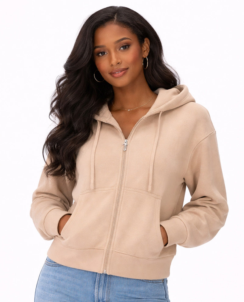 Woman wearing a beige hoodie on a white background