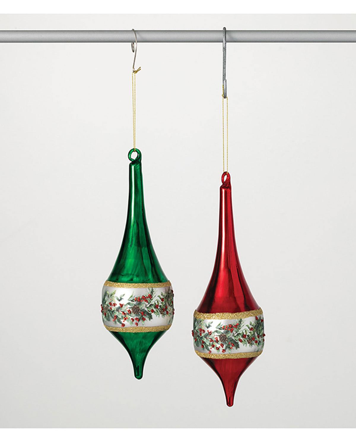 Two glass Christmas ornaments, one green and one red, hanging on a white background.