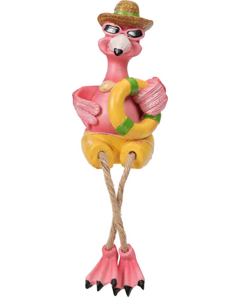 A pink flamingo figurine wearing a brown straw hat, black sunglasses, yellow shorts, and holding a yellow life preserver with green stripes. The flamingo has long legs ending in pink flip-flop shoes with black toes, and its hands and feet are attached by ropes.
