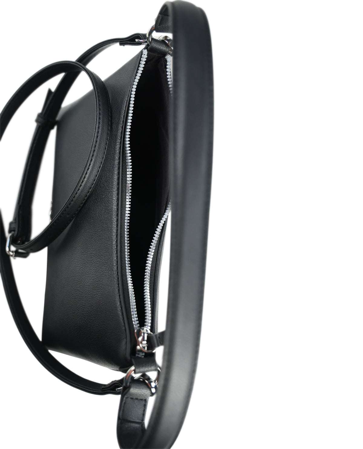 A close-up side view of a black leather shoulder bag with a silver zipper and a thin black strap, set against a plain white background.