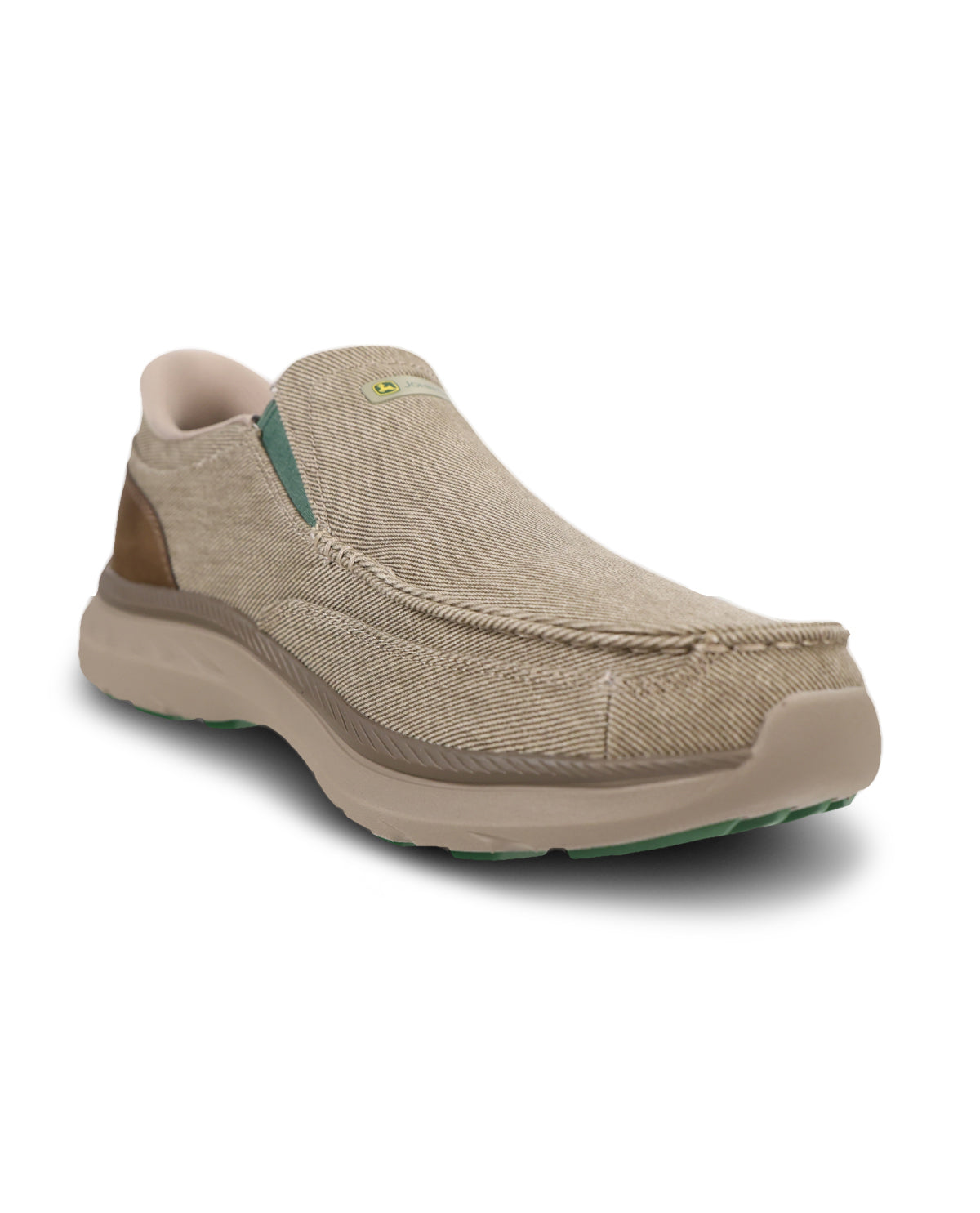 A slip-on casual shoe in a textured beige fabric upper with a thick beige sole, brown heel accent, and a small green logo tab, shown on a white background.