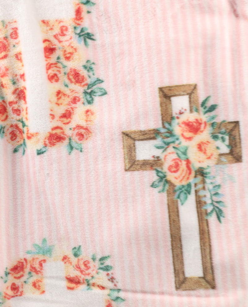 Floral cross design on a pink background