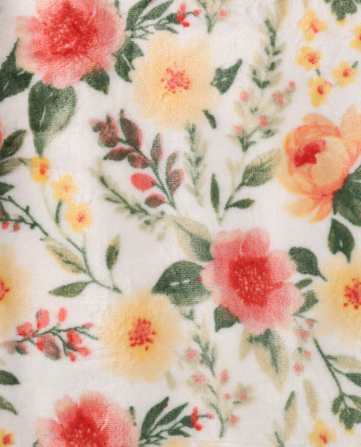 A close-up of a white fabric with a soft, plush texture featuring a watercolor-style floral print of pink, yellow, and orange flowers with green leaves.