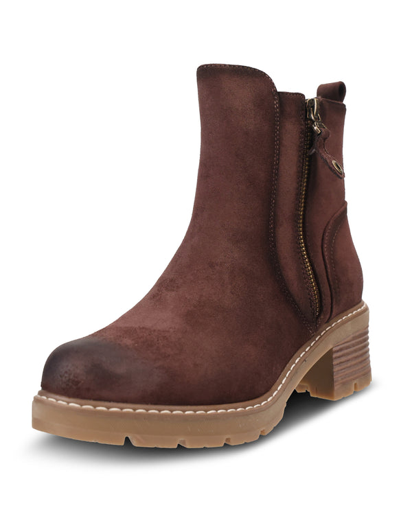 A dark brown suede ankle boot with a side zipper, chunky lug sole, and stacked block heel, shown on a white background.