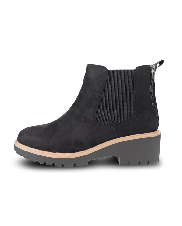 A single black suede Chelsea-style ankle boot with a ribbed elastic side panel, a low chunky gray block heel, and a light tan midsole, shown from a side profile on a white background.