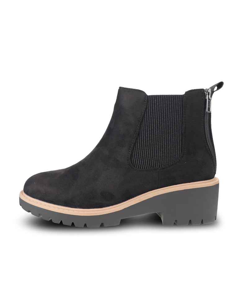A single black suede Chelsea-style ankle boot with a ribbed elastic side panel, a low chunky gray block heel, and a light tan midsole, shown from a side profile on a white background.