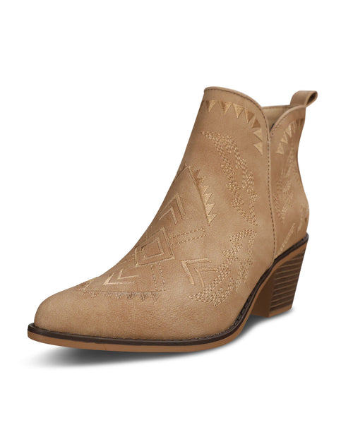 A light tan suede ankle boot with a low stacked heel and embossed geometric western-style stitching, shown from a three-quarters angle on a white background.