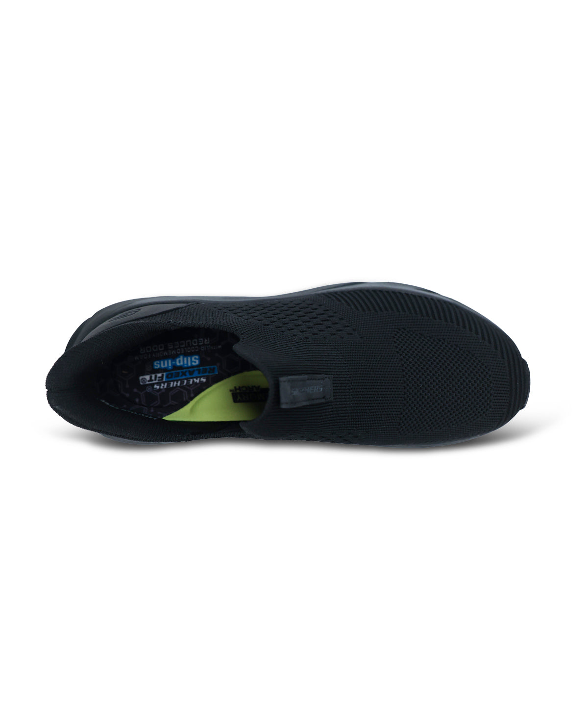 A black slip-on shoe shown from a side profile view, featuring a textured black upper and sole with a small lime green accent visible inside the heel area.