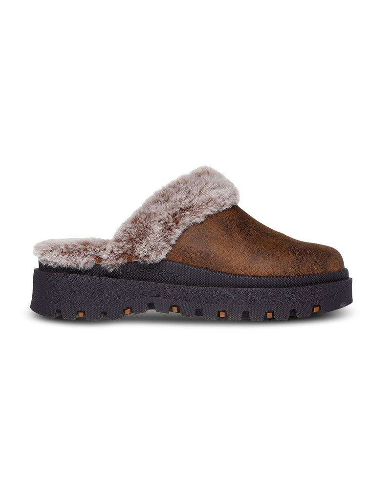 Brown slip-on shoe with fur lining on a white background