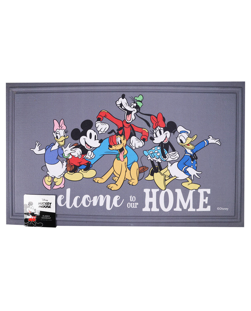 A rectangular gray welcome mat featuring Disney characters including Mickey Mouse, Minnie Mouse, Donald Duck, Daisy Duck, Goofy, Pluto, and Tweety, with the text 'Welcome to our HOME' in white. A small Mickey Mouse card and a black-and-white box are placed in front of the mat on a white background.