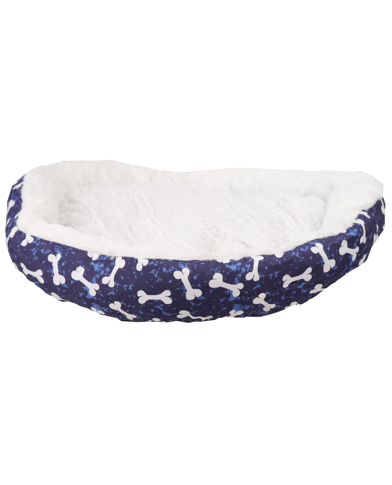 A pet bed with a navy blue glittery exterior patterned with white bones, and a plush white faux fur interior, shown against a plain white background.