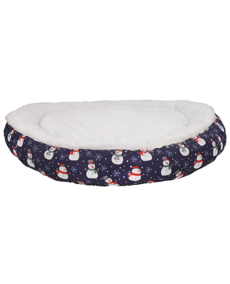 A round pet bed with a navy blue snowman patterned fabric exterior and a plush white faux fur interior, shown against a plain white background.