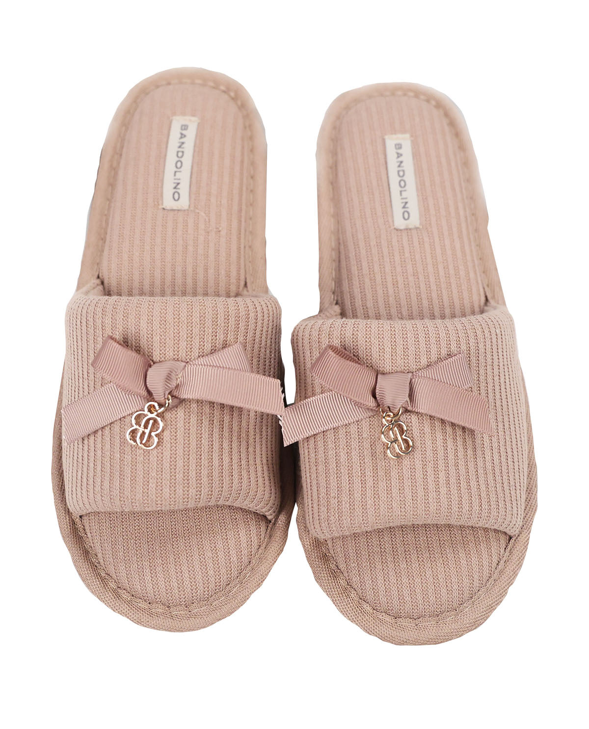Pair of beige slippers with pink bows and gold charms on a white background