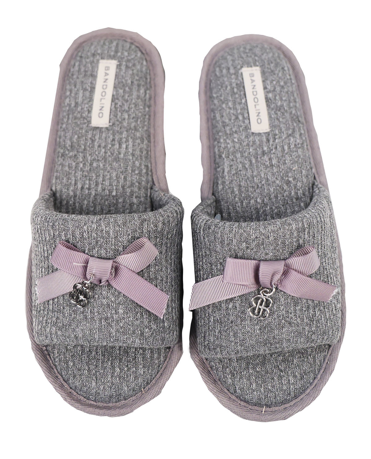 Pair of gray slippers with purple bows and a brand label on a white background