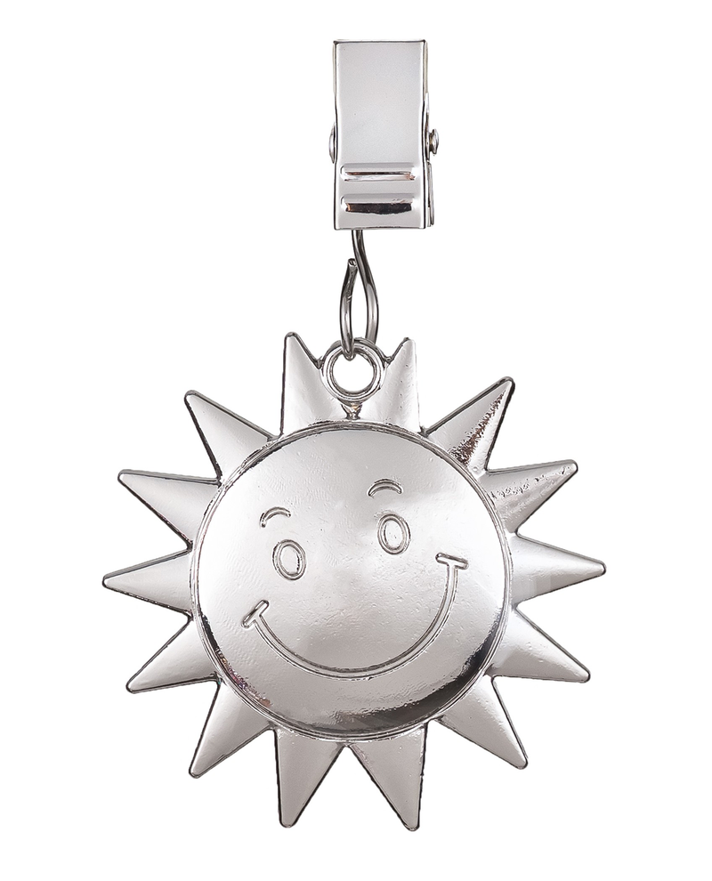 Silver sun-shaped charm with a smiley face on a white background