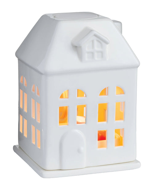 White ceramic house-shaped lamp with glowing interior on a white background
