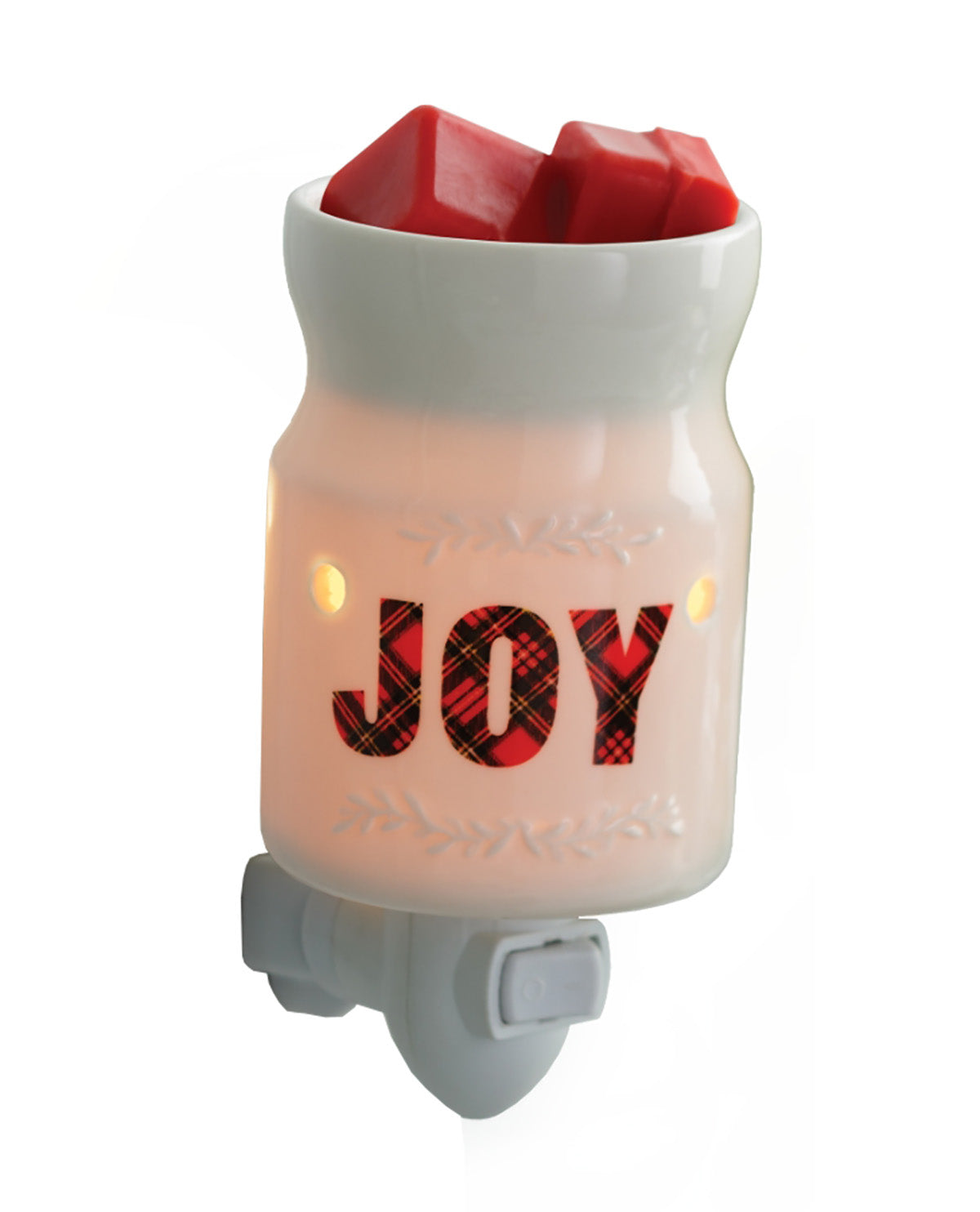 A holiday-themed night light in the shape of a milk carton, featuring a white body with a warm white glow, red wax melts at the top, and the word 'JOY' in red and black plaid lettering. The base is gray with a power switch.