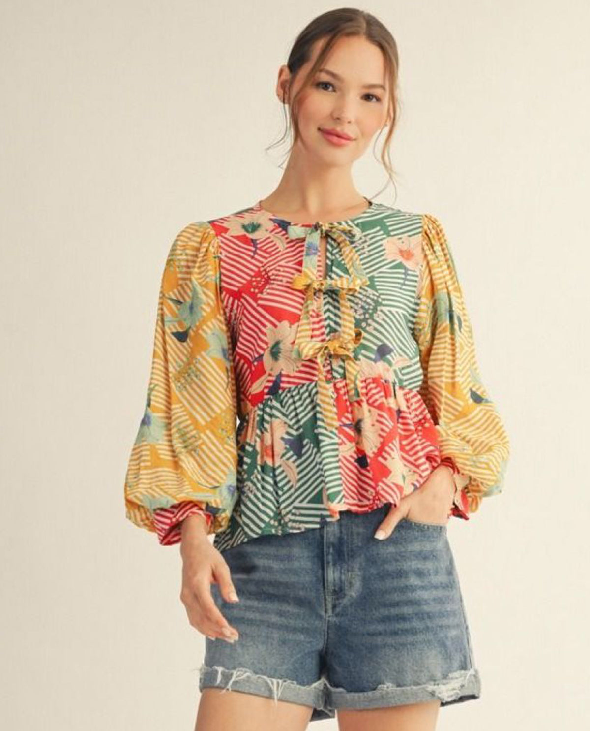 Jodifl 3/4 Puff Sleeve Color Blocked Floral Top With Front Bow Tie Detail