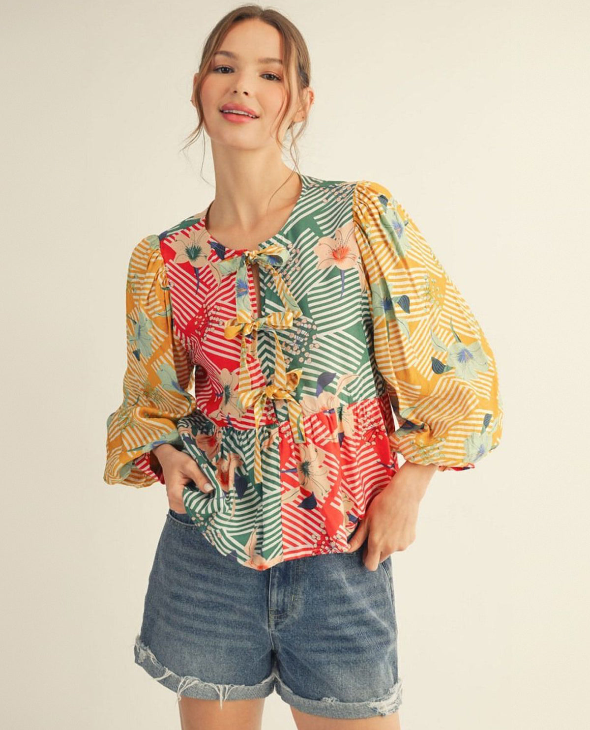 Jodifl 3/4 Puff Sleeve Color Blocked Floral Top With Front Bow Tie Detail