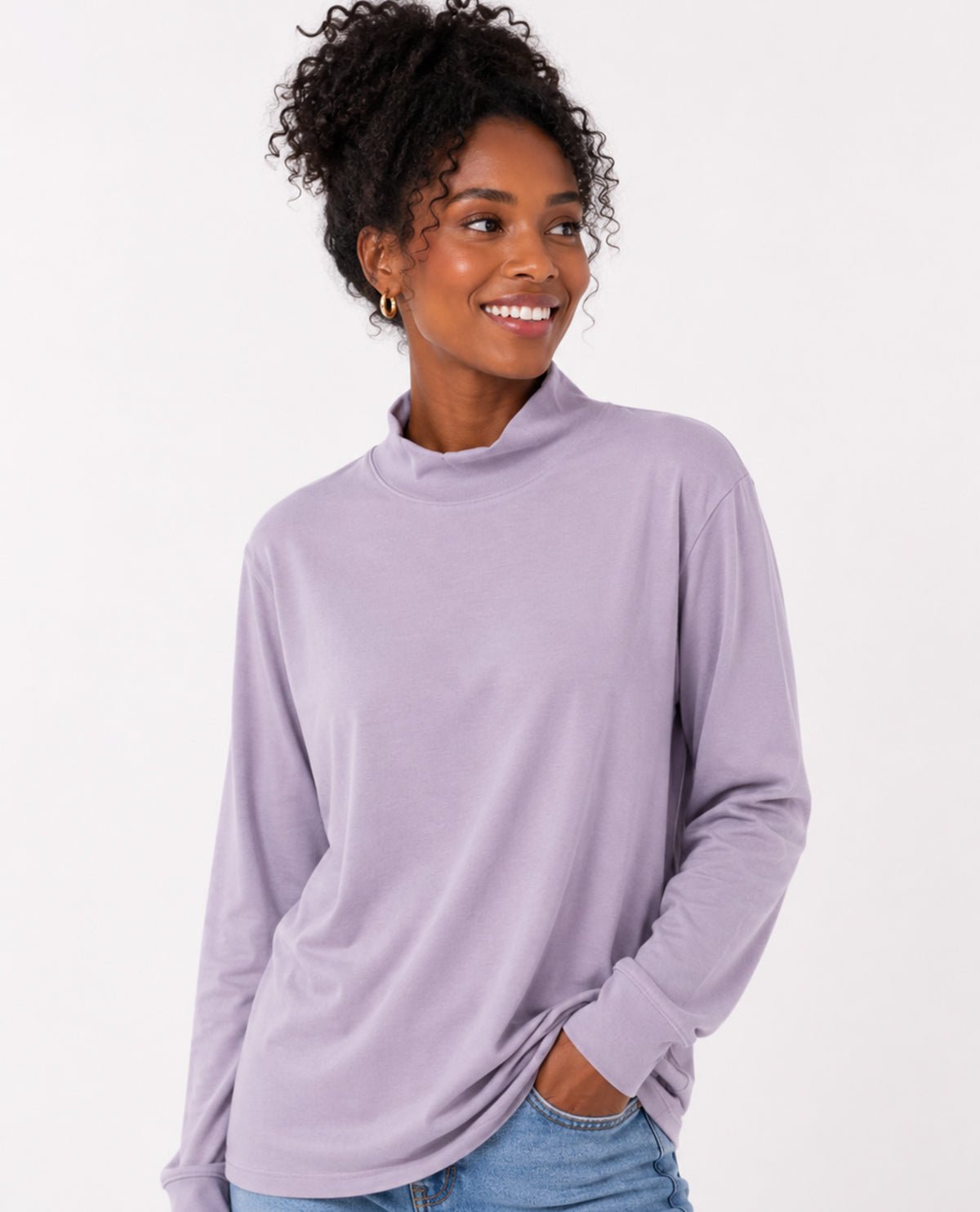 Woman wearing a light purple long-sleeve top on a white background