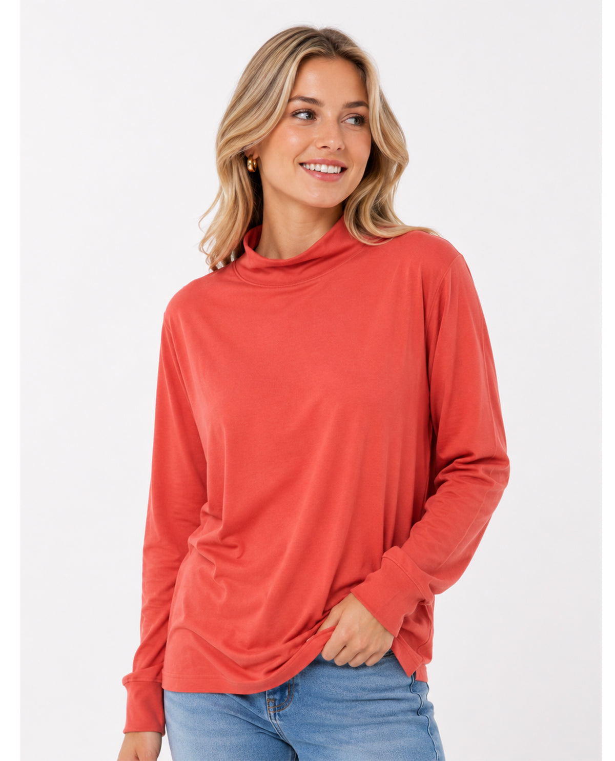 Woman wearing a red long-sleeve top on a white background