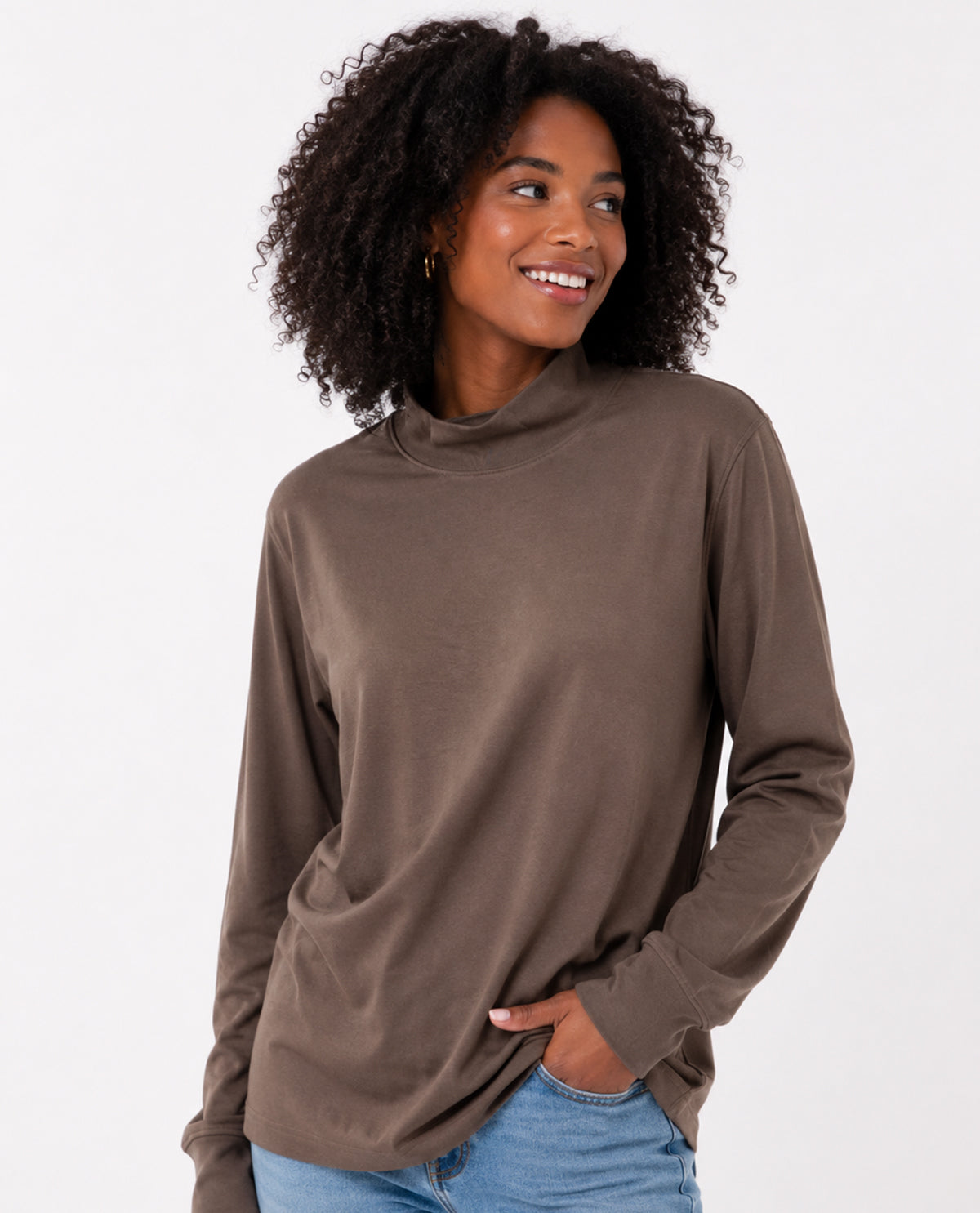 Woman wearing a brown long-sleeve top on a white background